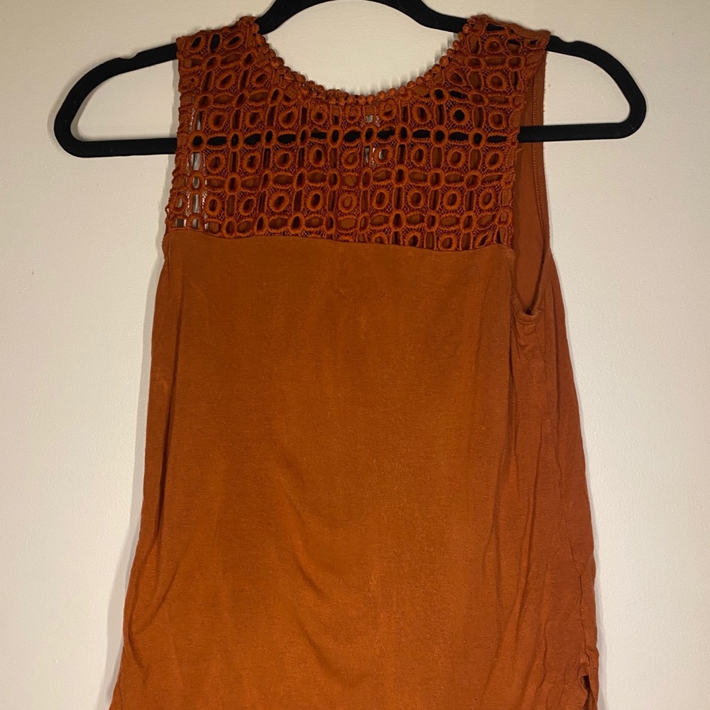 Rust orange sleeveless blouse